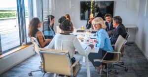 Diverse individuals sitting around a boardroom table